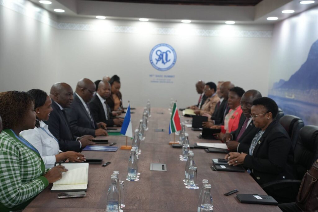 Lesotho Prime Minister Samuel Ntsokoane Matekane and South African President Cyril Ramaphosa sit with their respective delegations during bilateral discussions in Durban, South Africa.