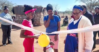 Deputy Prime Minister Thulisile Dladla cuts the ribbon during the handover of a new house to a vulnerable family in Nkilongo Inkhundla.