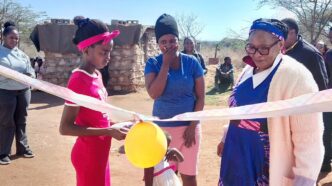 Deputy Prime Minister Thulisile Dladla cuts the ribbon during the handover of a new house to a vulnerable family in Nkilongo Inkhundla.