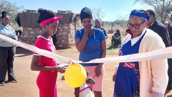 Deputy Prime Minister Thulisile Dladla cuts the ribbon during the handover of a new house to a vulnerable family in Nkilongo Inkhundla.