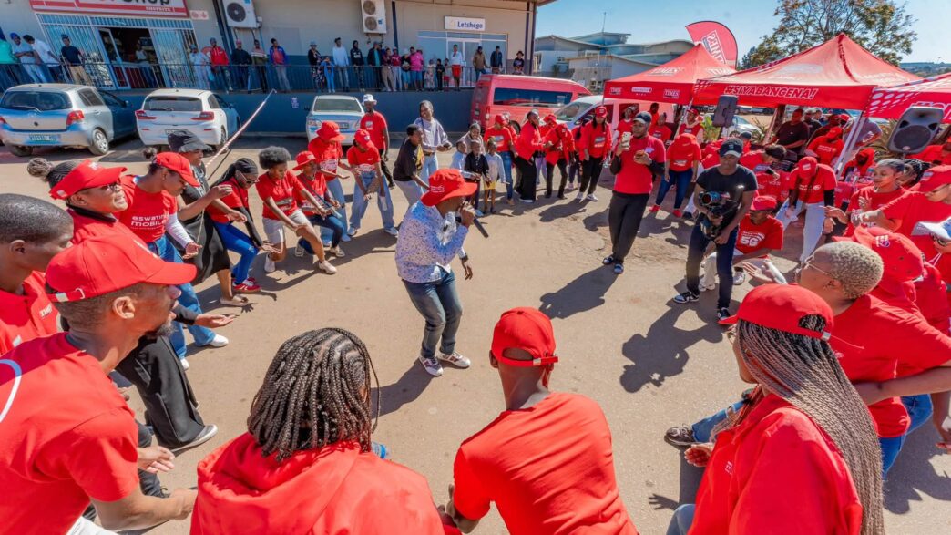 Customers dance during the e-Mali activation event at an Eswatini Mobile service point.
