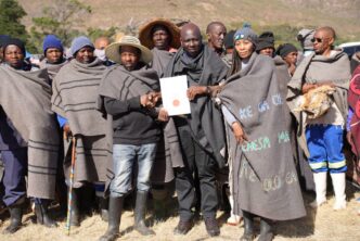 Minister of Environment and Forestry Thabo Mofosi joins pastoralists and livestock farmers for a group photograph during the commemoration of the International Year of Rangelands and Pastoralists at Ha ’Matsa, Matelile, Mafeteng, Lesotho.