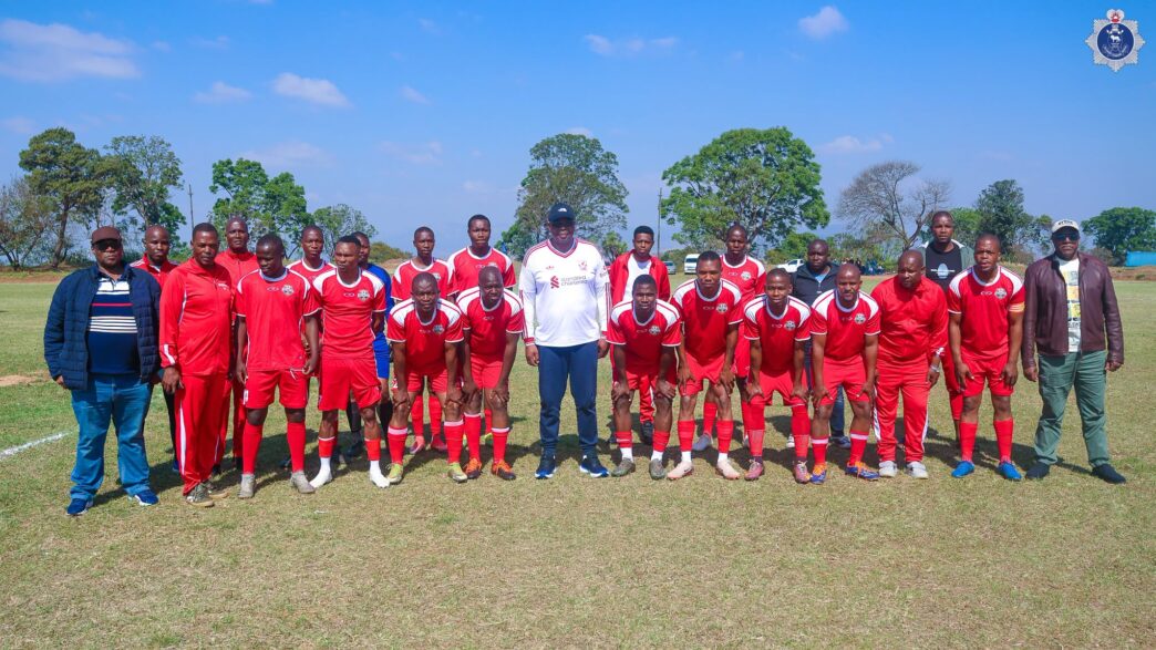 National Commissioner of Police Vusi Manoma Masango poses with members of one of the football teams during the NATCOM Cup Games at the Matsapha Police Academy.
