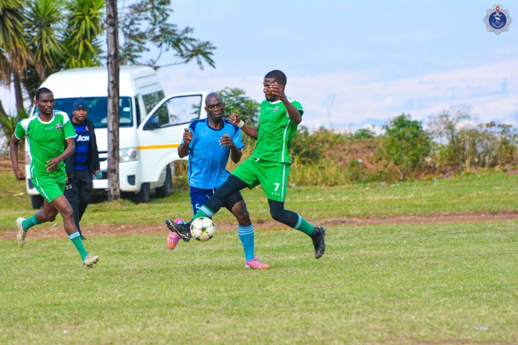 Police officers battle for possession during a soccer match in the NATCOM Cup Games.