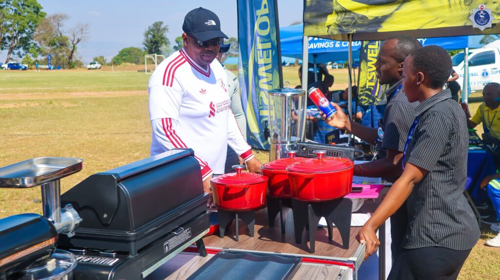 National Commissioner of Police Vusi Manoma Masango engages exhibitors at one of the stalls during the NATCOM Cup Games at the Matsapha Police Academy.