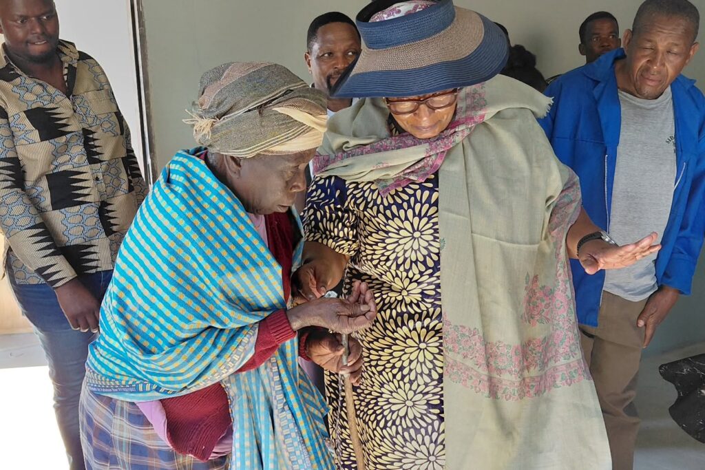 Deputy Prime Minister Thulisile Dladla hands over the keys to one of the beneficiaries during the official handover of new homes.
