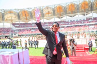 Zambian President Hakainde Hichilema waves to supporters at the National Heroes Stadium following his swearing in for a second term.