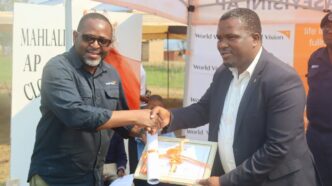 Amos Zaindi presents the facility to Minister S’khumbuzo Dlamini. Photo: World Vision Eswatini