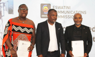 Icon Connect Radio representative Phila Koshini and Sakha Live FM representative Melusi Dlamini pose with ESCCOM Acting Chief Executive Officer Ozzie Thakatha after receiving their commercial radio broadcasting licences